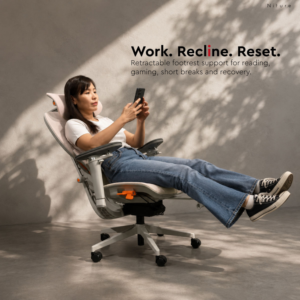 Person reclining in SINC Air with retractable footrest extended